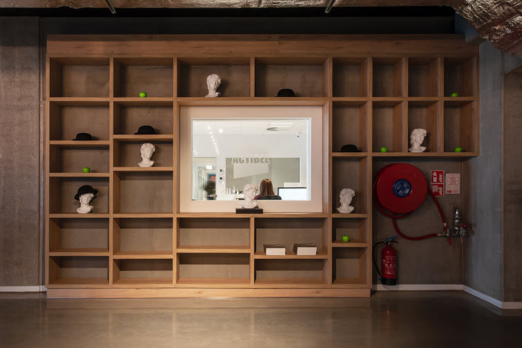 A large wall rack in HPL surrounds the window with a view of Actibel’s offices